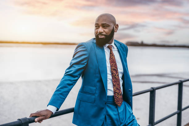 istock Black guy in a blue suit outdoors 1442844683