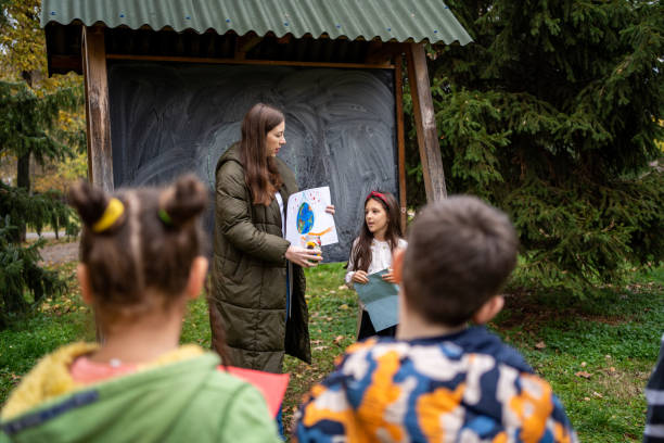 istock Woman teaching kids about environmental conservation at public park 1442844997