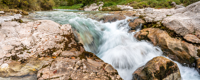 The Soca river flowing through a wild mountain landscape of the Julian Alps, Slovenia