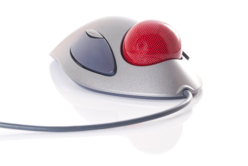 Trackball, a computer pointing device, with reflection, isolated on white background. Shallow depth of field.