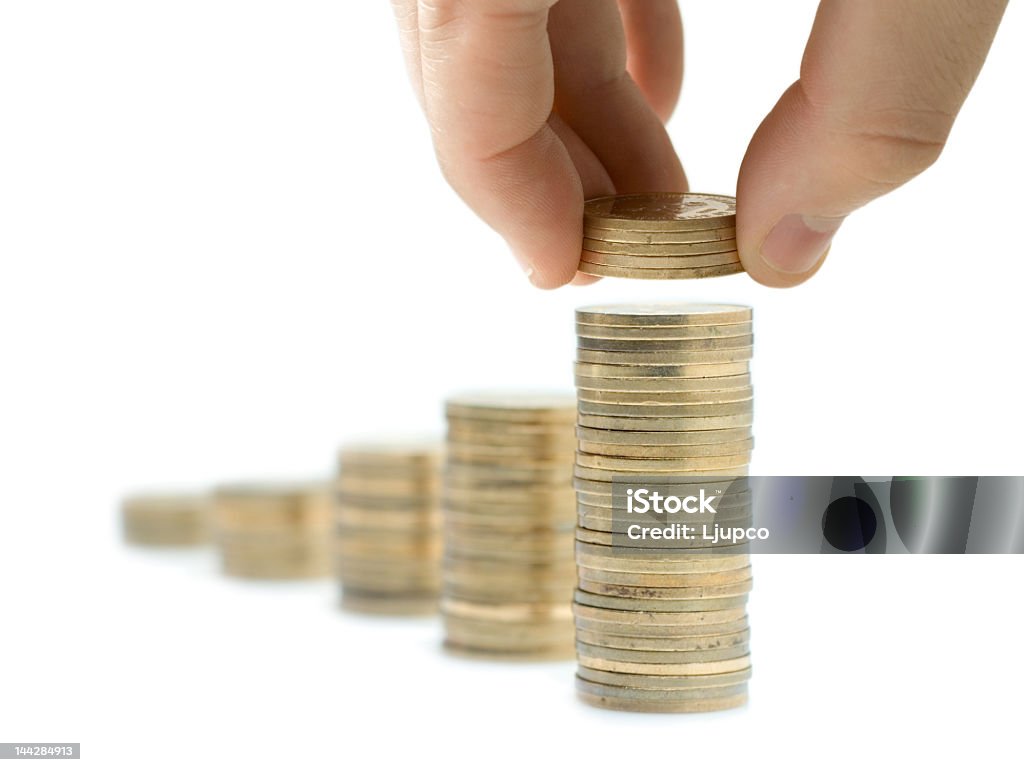 Person laying more quarters on top of a pile of quarters Increase your savings  Architectural Column Stock Photo