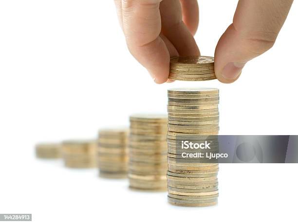 Person Laying More Quarters On Top Of A Pile Of Quarters Stock Photo - Download Image Now