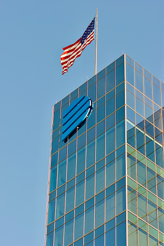 Richmond, Virginia, USA - November 19, 2022: The U.S. flag flies atop Dominion Energy’s Corporate Headquarters building in downtown Richmond on a sunny afternoon.
