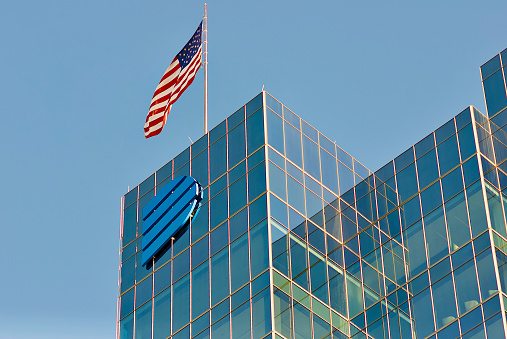 Richmond, Virginia, USA - November 19, 2022: The U.S. flag flies atop Dominion Energy’s Corporate Headquarters building in downtown Richmond on a sunny afternoon.