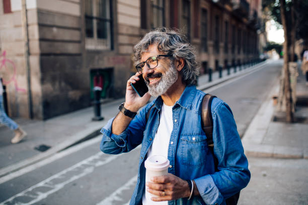 istock Mature tourist telephoning while sightseeing Barcelona 1442852256