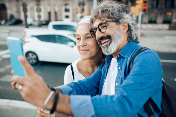 istock Happy mature couple on vacation taking a break and using smartphone 1442852267