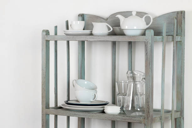 istock Vintage shelf with kitchenware on a white wall background. antique shelf. interior 1442852873