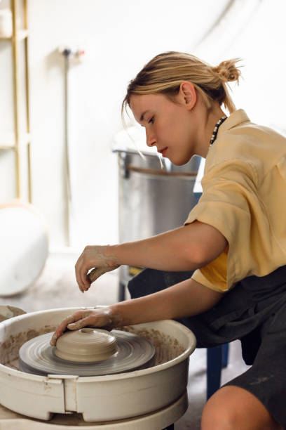 istock Young woman making pottery in her art studio 1442852881