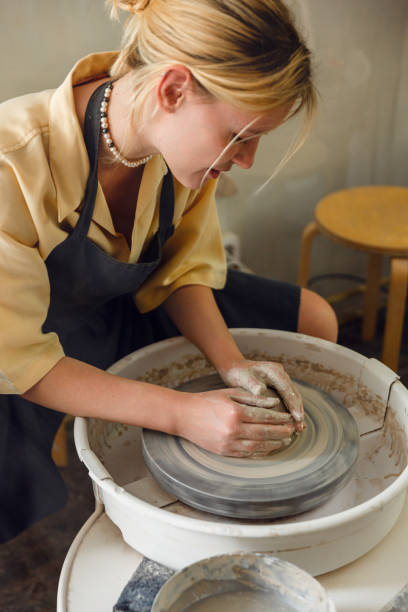 istock Young woman making pottery in her art studio 1442852883
