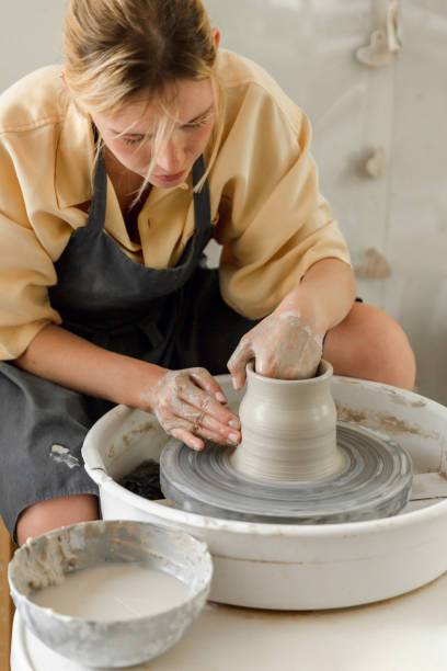 istock Young woman making pottery in her art studio 1442852885