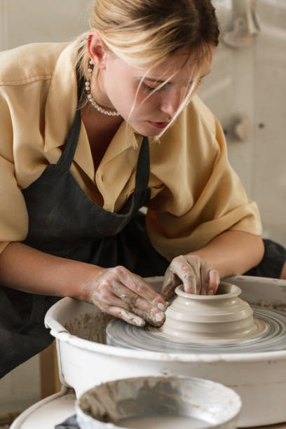 istock Young woman making pottery in her art studio 1442852887