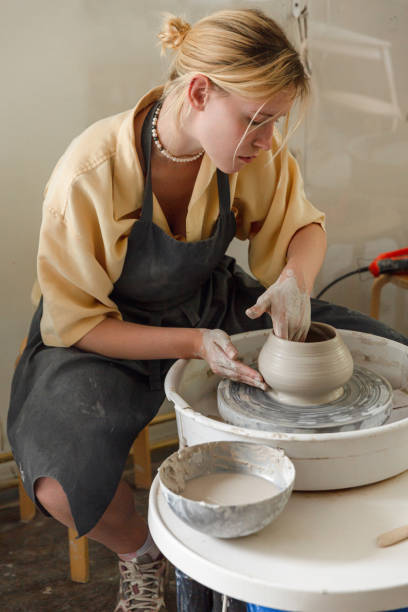 istock Young woman making pottery in her art studio 1442852888