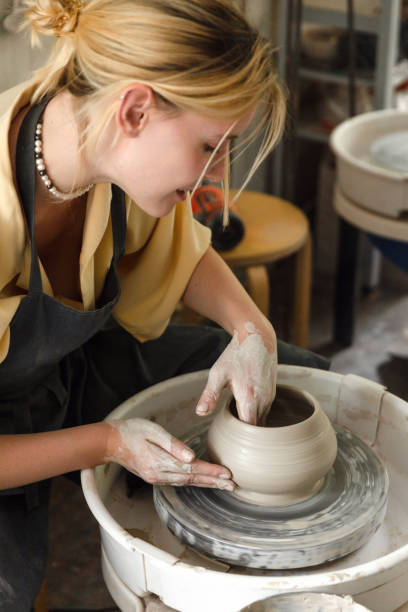 istock Young woman making pottery in her art studio 1442852890