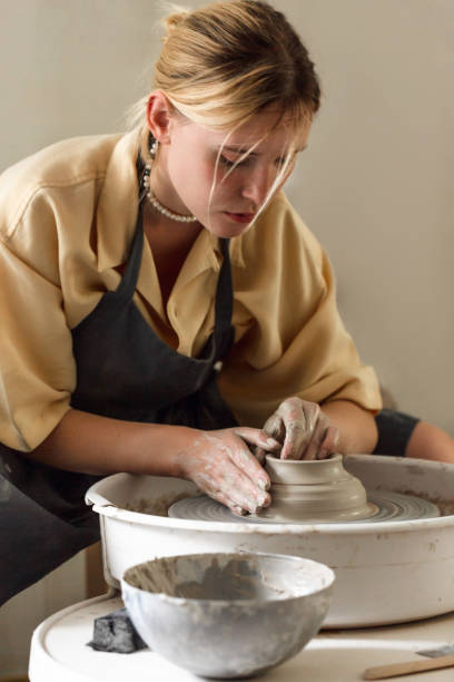 istock Young woman making pottery in her art studio 1442852923