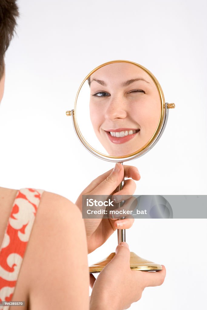 Wink in mirror Girl winks to her reflection in mirror 20-24 Years Stock Photo