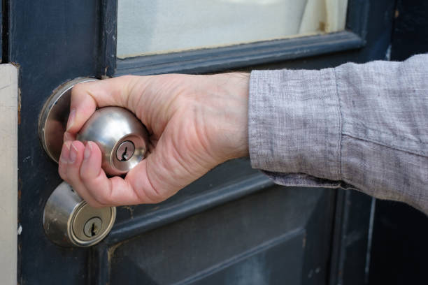 istock A man holding a door knob. 1442856121