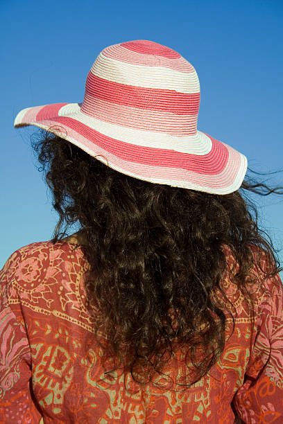stripy hat and curly hair brunette stock photo
