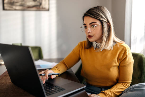istock Concentrated young beautiful woman working from home 1442860793