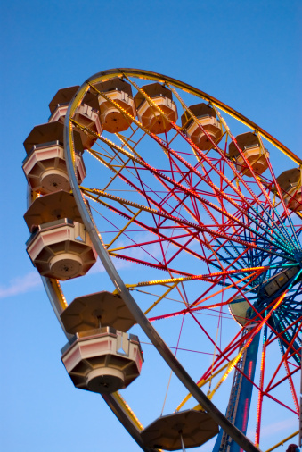 Colorful carnival ferris wheel at dusk