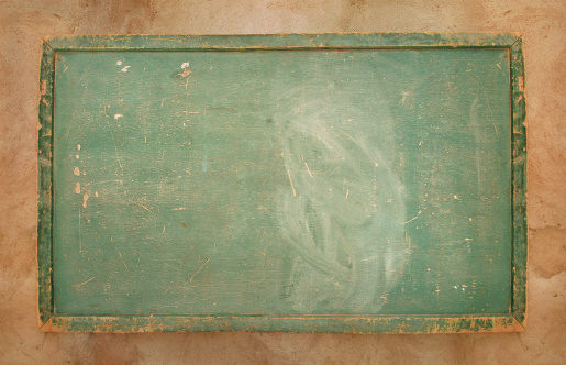 An old, green chalk board with eraser marks. Shot in Africa.