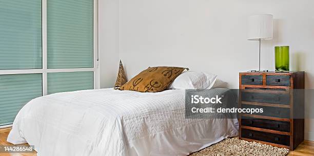Bedroom With A White Color Scheme And Brown Accents Stock Photo - Download Image Now