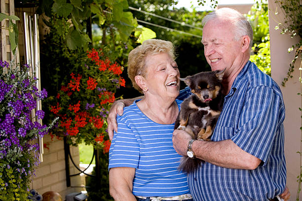 Smiling senior couple holding a puppy