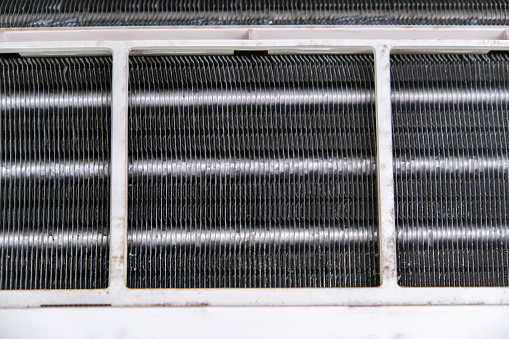 Mold and dust on the radiator grille of the air conditioner. Maintenance and cleaning of the split system.