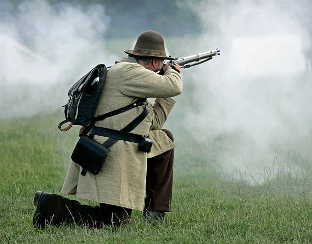 istock Confederate soldier firing rifle 144286795