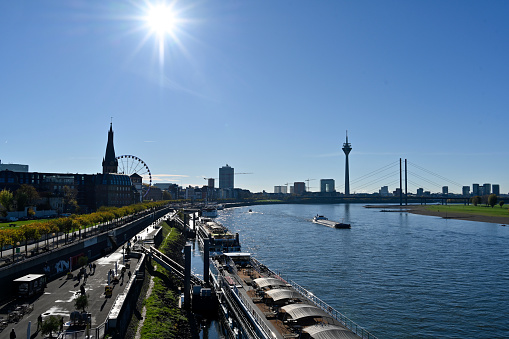 Düsseldorf, November 13, 2022 - The Rhine promenade in Düsseldorf with Ferris wheel, castle tower and Lambertus Basilica seen from the Oberkasselbrücke.