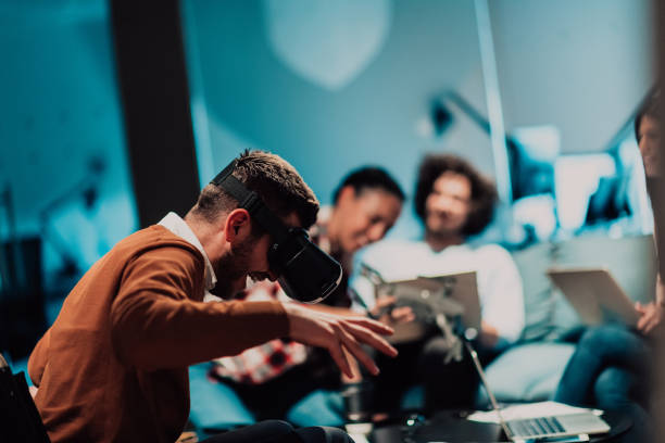 istock Business persons with a disability at work in modern open space coworking office on team meeting using virtual reality goggles. 1442872905