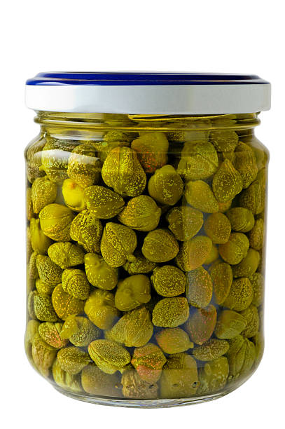 Glass jar of preserved capers with clipping path stock photo