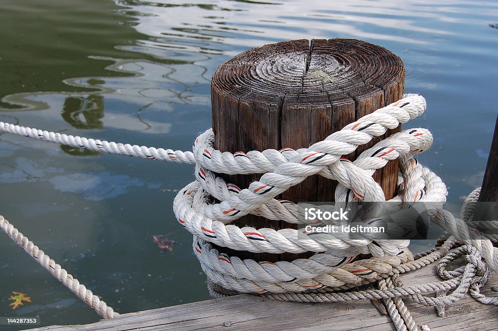 Rope Rope tied to dock. Bay of Water Stock Photo