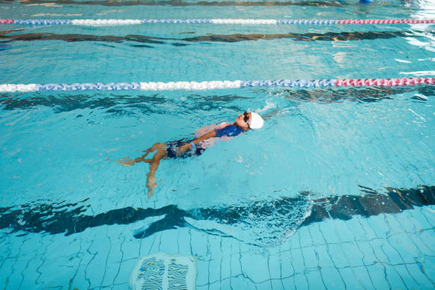 istock Little boy swimming underwater in pool. 1442877639