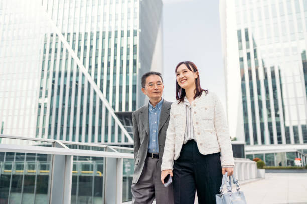 istock Two business people walking and talking about the business 1442880095