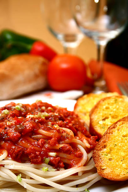 Spaghetti served with bread on a plate stock photo
