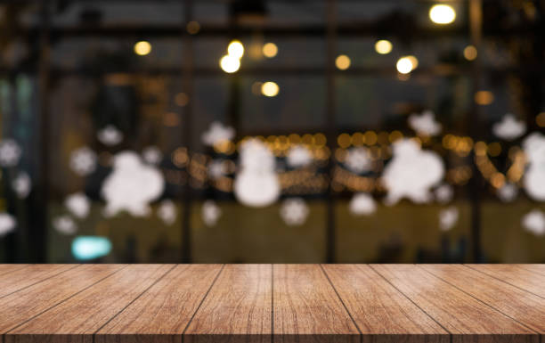 istock Empty wooden table top with lights bokeh on blur restaurant background. 1442892863