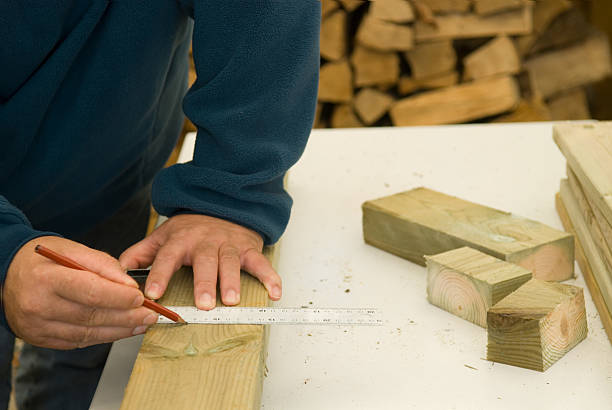 DIY craftsman marks a cutting guide line stock photo