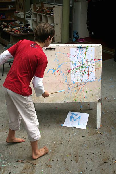 Young boy's splatter artwork stock photo