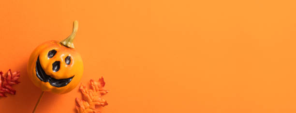 istock Creative Halloween design concept background with pumpkin, autumn leaves and copy space. 1442900289