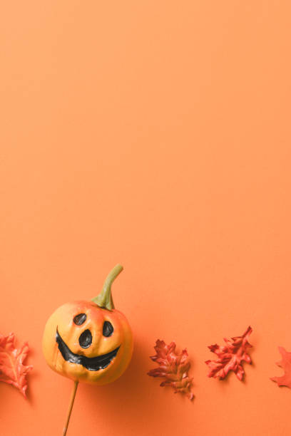 istock Creative Halloween design concept background with pumpkin, autumn leaves and copy space. 1442900361