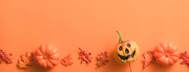 istock Creative Halloween design concept background with pumpkin, autumn leaves and copy space. 1442900433