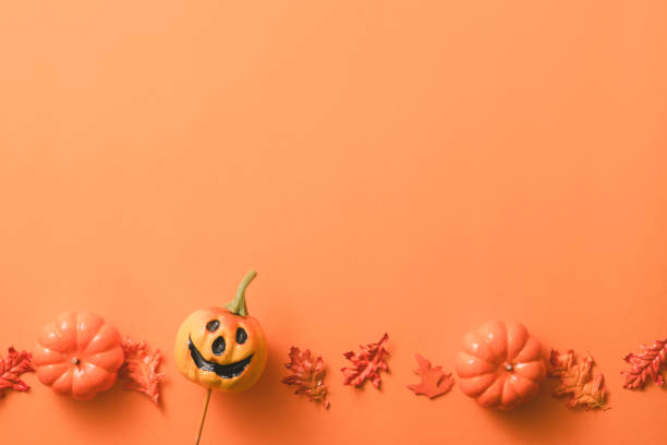 istock Creative Halloween design concept background with pumpkin, autumn leaves and copy space. 1442900606