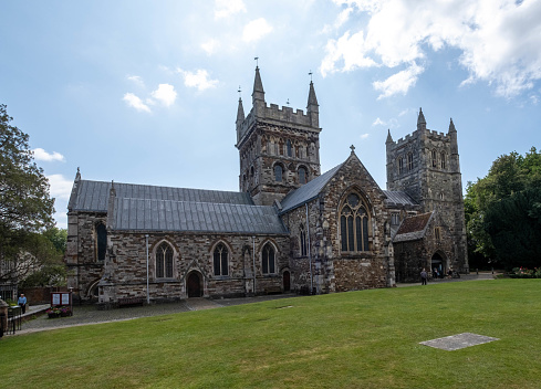 St Mary and All Saints Church in Chesterfield, England, with cars and people visible in the background