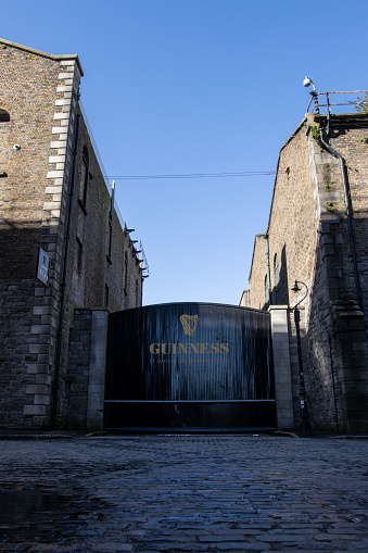 Dublin, Ireland – March 21, 2021: Ireland, Dublin, a view of Guinness St. James Gate brewery near the storehouse under the blue sky