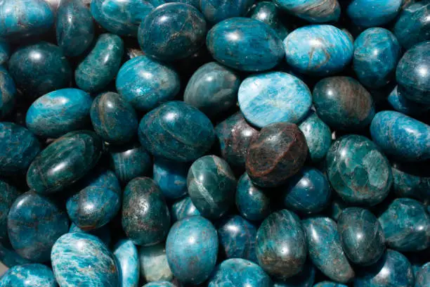 A top view of natural tumbled Apatite Stone pile under the light