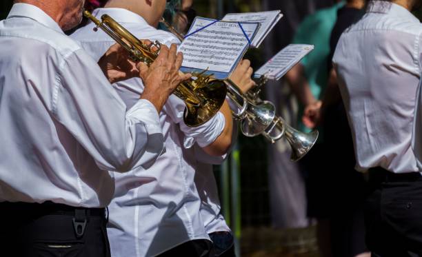 group of men playing trumpet in the marching band - marching band imagens e fotografias de stock