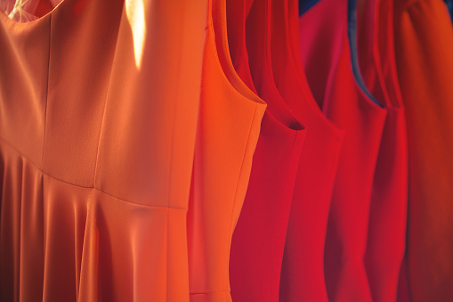 Orange silk satin curtain. Bright luxury background for design. Soft folds. Shiny golden draped fabric.  Wavy lines. Flowing. Fluid, liquid, ripple effect. Valentine, Mother's day, festive. Fiery.
