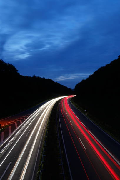 istock Long exposure of traffic light trails between forested hills during the blue hour 1442903812