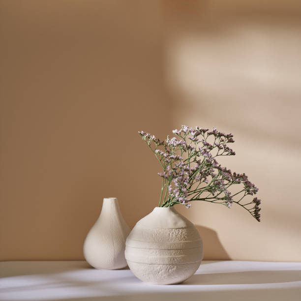 istock Marsh-rosemary in a white ceramic vase against a beige wall 1442903817