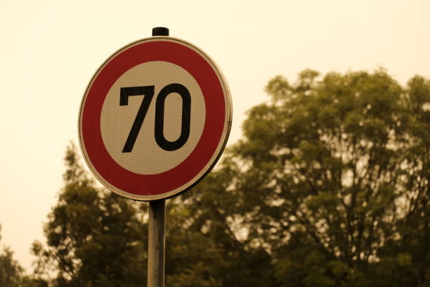 istock 70 mph traffic sign with trees in the background 1442904058